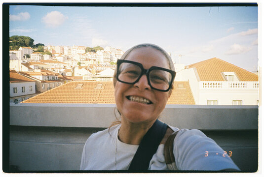 Smiling Woman Enjoys Sunny Day in Lisbon With City View