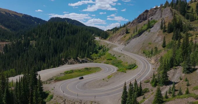 Elevated of iconic alpine switchback road winding by rugged Colorado mountains, Million Dollay Highway Colorado USA