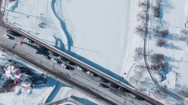 Aerial view of snowy bridge traffic in Port Credit Mississauga winter