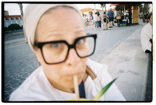 Woman Drink in a Lively Street