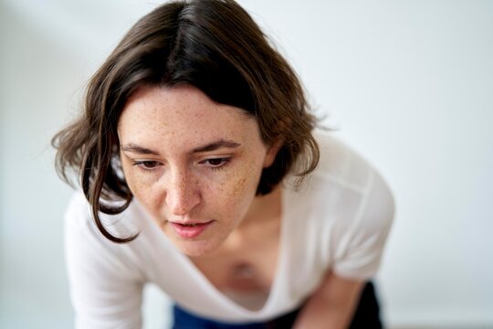 Woman Focused on Work in a Bright, Minimal Room