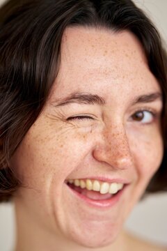 Joyful Moment Captured With a Playful Wink and Bright Smile