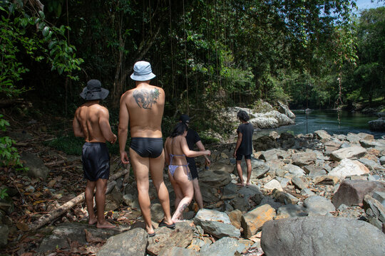 Group of Friends Exploring a Riverside at a Tropical Location