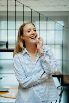 Woman Smiling Confidently in a Bright Modern Office Space