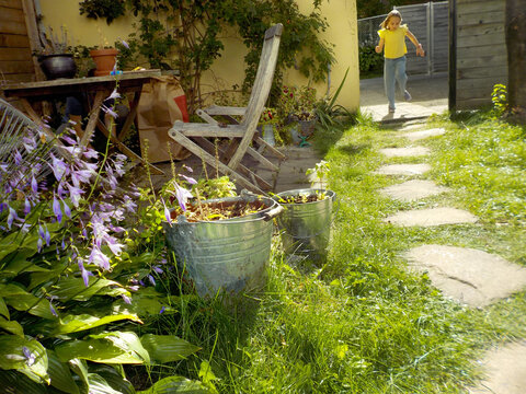 Child Running in Sunny Backyard Garden