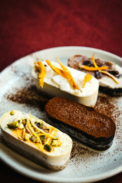 assorted vegan dessert bars on a rustic plate
