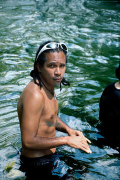 Swimming in a Natural River Surrounded by Greenery During Daylight