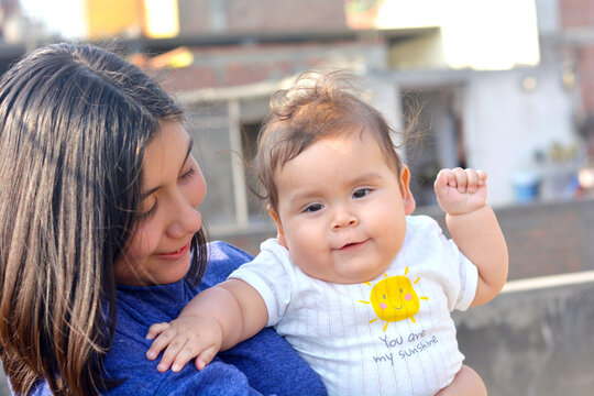 Latin baby with big sister.
