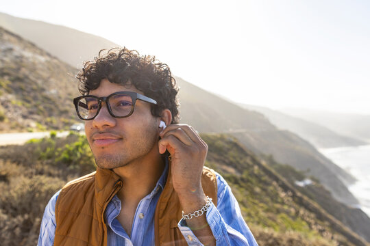 Handsome Mixed race man  portrait  listen earbuds