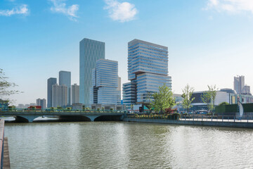 Obraz premium Tranquil Urban Reflection: Modern Architecture by a Serene Waterway