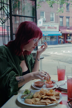 Woman eating nachos.