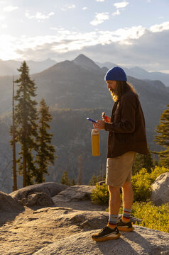 Hiker snack break rest mobile phone Yosemite National Park 