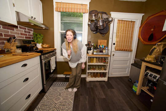 Woman Being Playful Pretending to Sing in Microphone