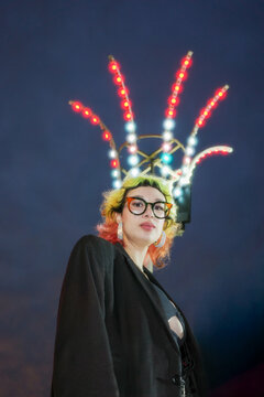 Alternative young woman in front of colorful lights 