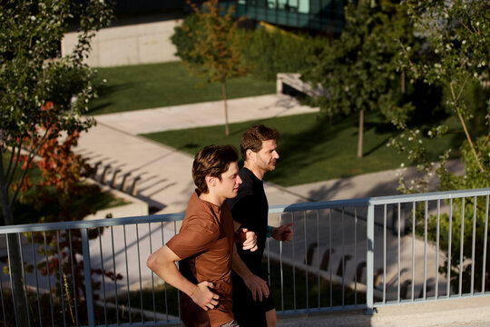 Trainer and client running side by side outdoors