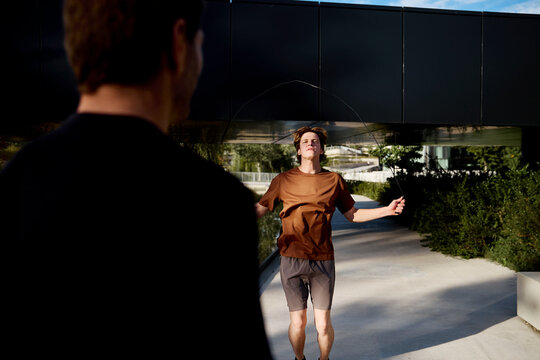 Trainer supervising client during outdoor training