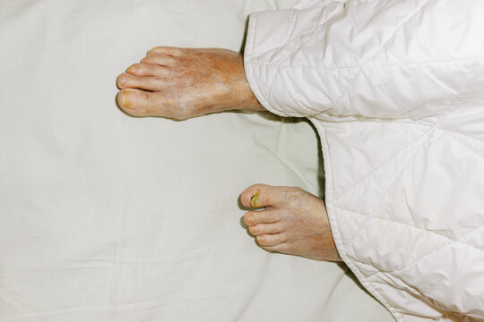 Feet Resting on a White Blanket in a Calm Indoor Setting