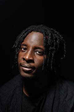 Confident man with dreadlocks under spotlight 
