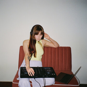 Home DJ Session: Stylish Woman Mixing on Controller