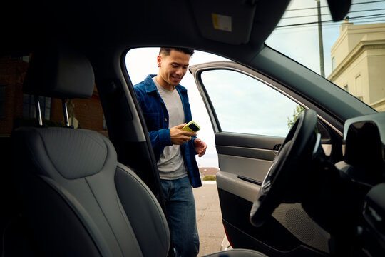 Smiling man gets into the car