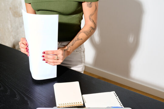 Anonymous businesswoman sorting documents