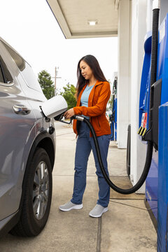 Asian woman refuel gas at station 