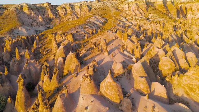Goreme, Nevsehir, Turkey. Detailed exploration of Devrent Valley revealing intricate erosion details and mineral variations in sunset light.. Aerial View