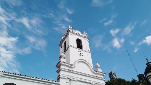 Tilt Down Reveal of Clock Tower and Cabildo Historic Colonial Government Building with Flags Buenos Aires Argentina