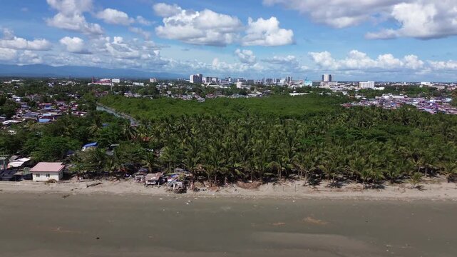 Drone aerial of Iloilo City highlighting modern skyline, residential districts, Rural Areas with River, and expanding infrastructure on Panay Island. Dynamic urban growth in the central Philippines.