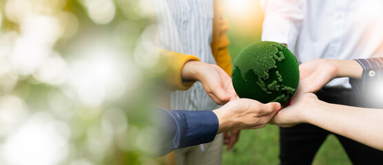 panoramic of hands people holding a green moss globe together in a park. Concept of...