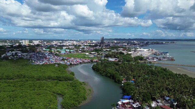 Drone aerial of Iloilo City highlighting modern skyline, residential districts, Rural Areas with River, and expanding infrastructure on Panay Island. Dynamic urban growth in the central Philippines.