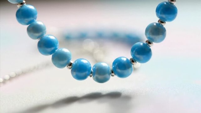 Close up of a blue beaded necklace with a blurred background