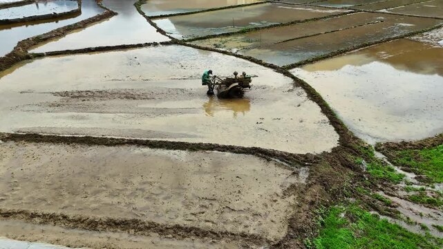 Tractor Plowing Muddy Paddies at Dawn, Irregular Fields Connected by Ridges, Real Shot