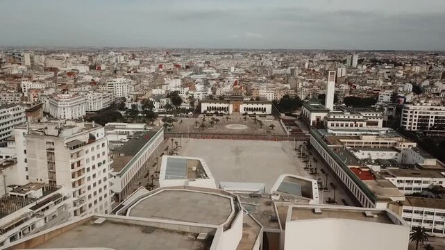 Aerial drone view of the iconic V Square. Captures the grand architectural heritage of Casablanca's civic center, featuring the city hall and the surrounding urban landscape.