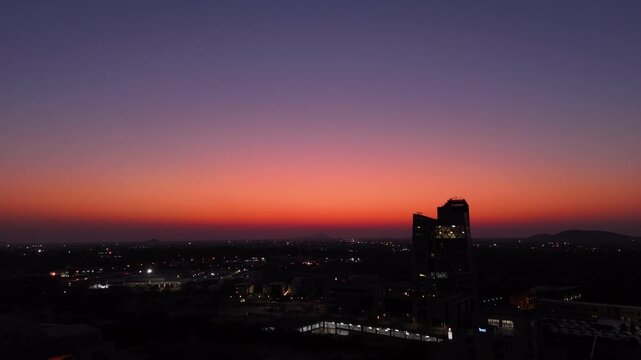 4K AERIAL VIEW OF SKYCRAPPERS IN EVENING GOLDEN RED SUNSET SKY - GABORONE BOTSWANA