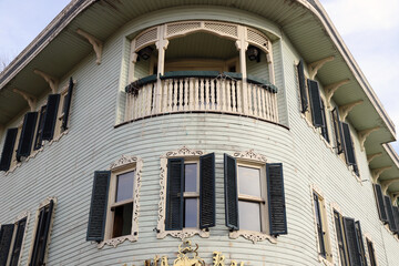 Historic Wooden Building with Rounded Corner Balcony, Traditional Wooden Facade with Curved Balcony Design