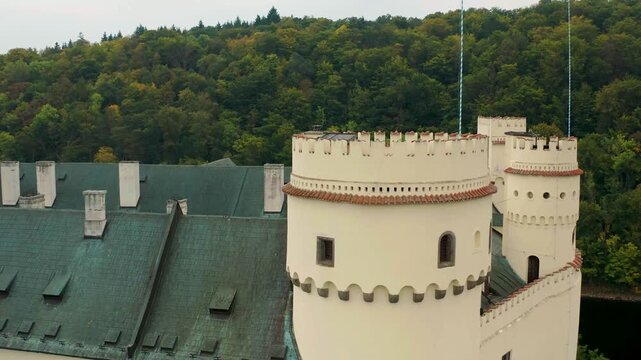 drone flying around the main tower of castle orlik in czech republic also the river n mountain around the castle