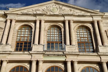 Historic Building Facade with Triangular Pediment, Close-Up of Heritage Building Front with Columns