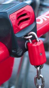 Close Up of Red Shopping Trolley Lock and Chain Mechanism