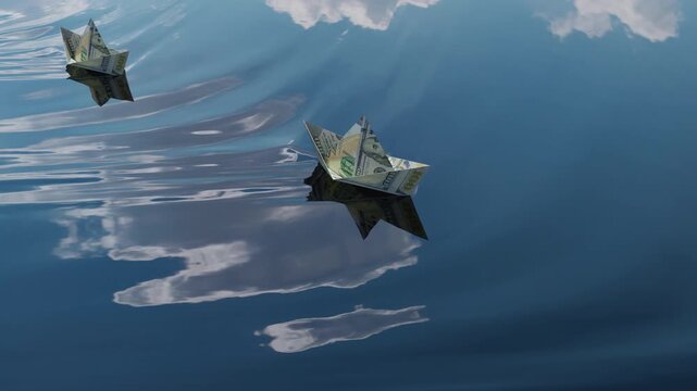 Seamless loop of origami paper boats made from dollar bills floating on calm water for financial and investment concepts