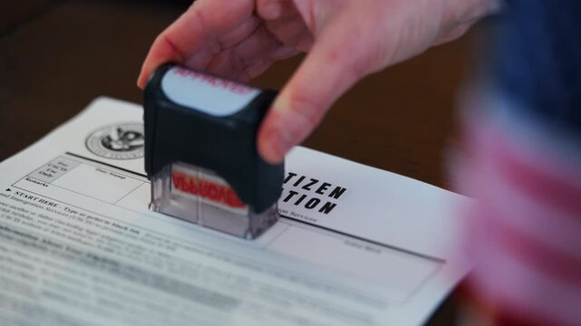 Close up of Visa application form with red Approved stamp, USA immigration and travel authorization concept.