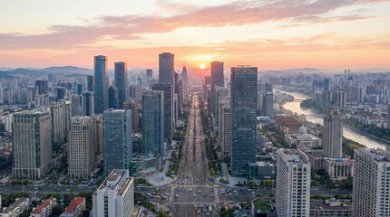 Fototapeta premium Aerial view of modern city skyline at sunset with river and urban architecture