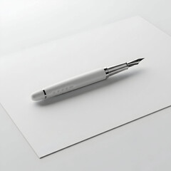 A white pen with a silver tip lies horizontally
