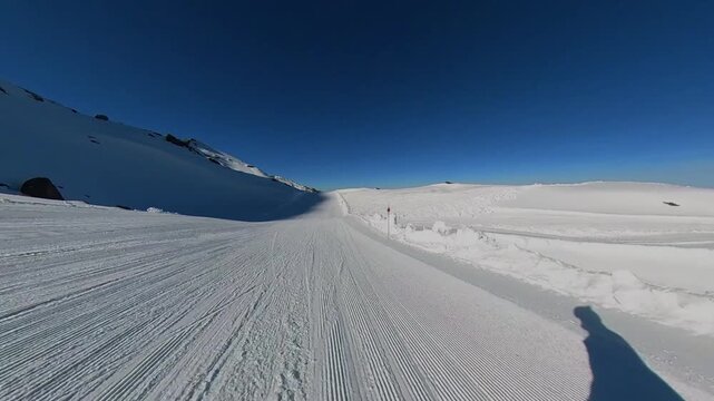 4K First-person perspective of a high-speed descent through the Laguna de las Yeguas glacial valley in Sierra Nevada, Spain, gliding on a technical red-marked winter trail.