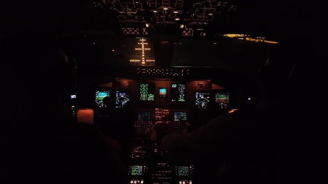 An immersive real time cockpit view in a bumpy final approach to Ibiza due to severe wind conditions, flying over the threshold. Night flight.