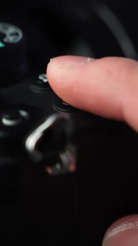 Macro close-up of a finger pressing the REC key on a mirrorless camera, starting recording in a studio setup for content creation.