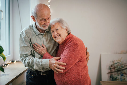 Romantic moment for senior couple at home, celebrating Valentines day.