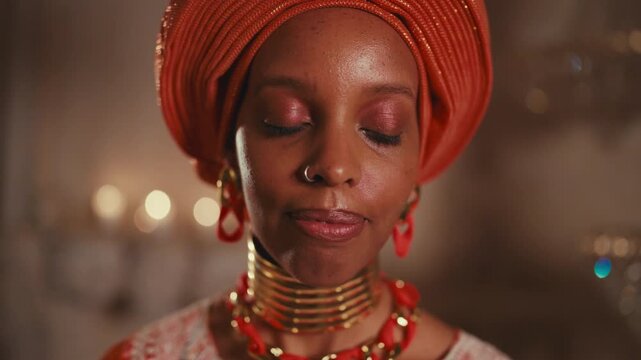 Beauty of african woman in traditional turban and gown, portrait in studio. Gorgeous black lady looking at camera, closeup of face, ethnic aesthetic and culture, diversity of female appearance, beauty