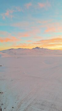 Dramatic Fiery Sunset Over Snowy Mountain Landscape &ndash; Aerial Drone View, Mount Aragats is visible from the valley