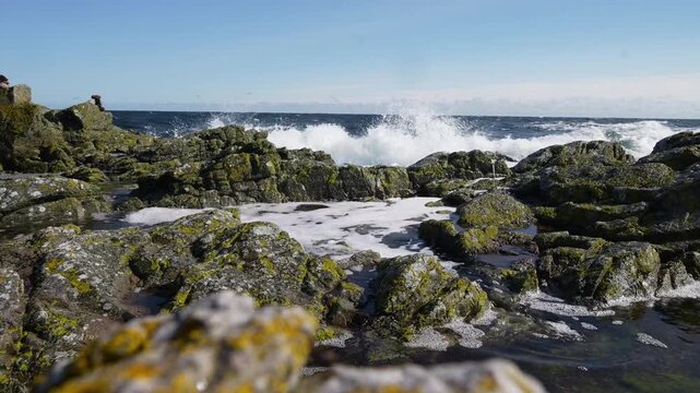 Sea waves run over large stones